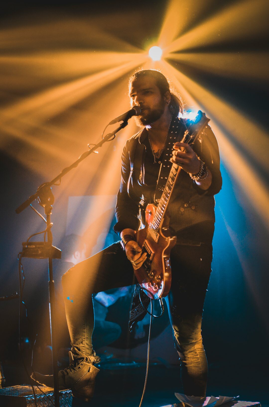 singer on stage with guitar